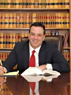 Warwick RI attorney Paul J. Ferns sitting at desk